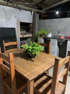 a wooden table with a potted plant on it at Casa da lagoa Doce!! in Imbituba