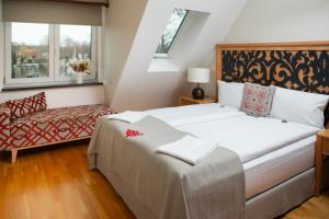 a bedroom with a large bed and a chair at Hotel Altes Fährhaus in Berlin