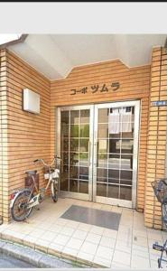 a motorcycle parked in front of a building at Skytree Residence 錦糸町 駅から600M徒歩8分 in Tokyo