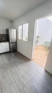 a kitchen with a stainless steel refrigerator in a room at Villa Bleue Agadir climatisée-centre-3chambres in Agadir +9 photos