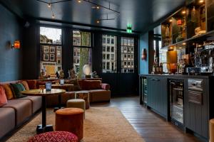 a living room with a couch and a table at Hotel Mai Amsterdam in Amsterdam