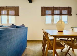a living room with a table and a couch at Canaryislandshost l Girasol in Punta de Mujeres