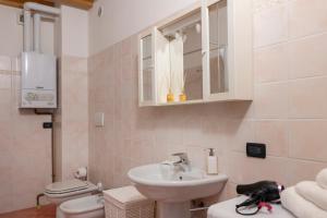 a white bathroom with a sink and a toilet at La Corte Moderna nel centro storico - idromassaggio in Clusone +31 photos