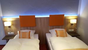 Postel nebo postele na pokoji v ubytování Hotel Trutzpfaff