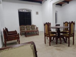 a dining room with wooden chairs and a table at Riverside in Bentota