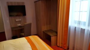 Postel nebo postele na pokoji v ubytování Hotel Trutzpfaff
