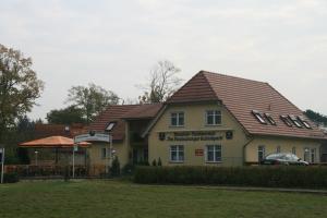 a house with a roof on top of it at Pension Am Rheinsberger Schloßpark in Rheinsberg +10 photos