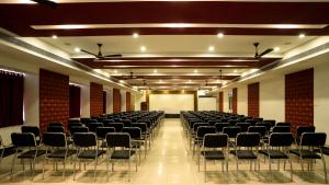 a large room with rows of chairs in it at Sakthi River Resort in Pollāchi