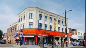 a building on the corner of a city street at Pacific Inn London Heathrow in Southall