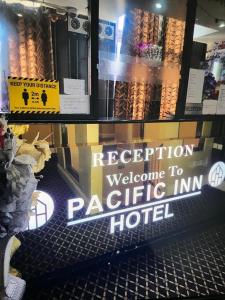 a sign that says reception welcome to packetific inn hotel at Pacific Inn London Heathrow in Southall