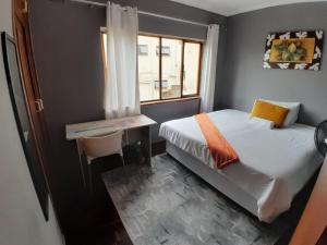 a small bedroom with a bed and a window at 54 Malcolm Hidden Gem near Musgrave in Durban +38 photos
