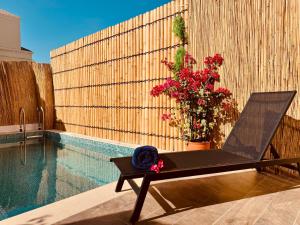 a chair sitting next to a swimming pool at Western Townhouse with swimming pool in Ras al Khaimah