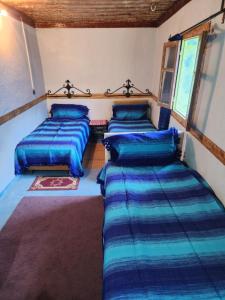 Uma cama ou camas num quarto em Gîte de montagne Azilane