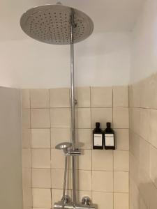 a shower light in a bathroom with white tiles at Casa Costa Apartments in Bajamar +69 photos