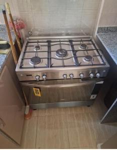 a stove top oven sitting in a kitchen at Compound Montaza hadayaq October in 6th Of October