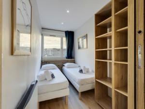 a small room with two beds and a mirror at Appartement rénové et lumineux à Tignes le Lac, proche des pistes et commodités - FR-1-641-10 in Tignes