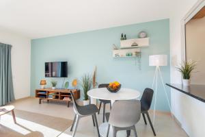 een woonkamer met een witte tafel en stoelen bij Bay View T1 - By Smarthomes in São Martinho do Porto