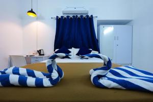 Postel nebo postele na pokoji v ubytování Madras Inn Nungambakam