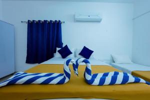 Postel nebo postele na pokoji v ubytování Madras Inn Nungambakam