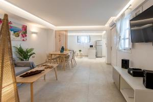 a living room with a couch and a table at Santorini Villatzio Suites in Mesaria