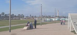 a group of people sitting on a bench in a park at single bed small room in Casablanca