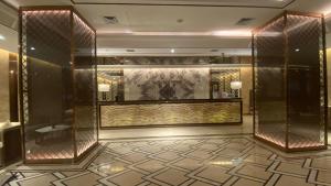 a lobby with a large wall of glass at Vunna Apartemen pollux habibi in Batam Center