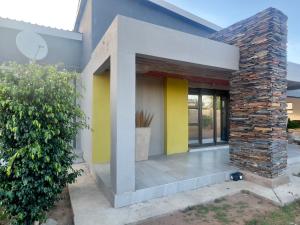 a house with yellow and yellow walls at Grace Boutique Guest House in Manamakgoteng