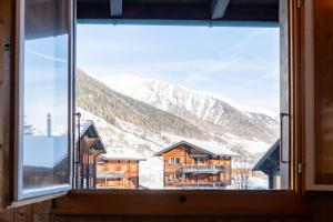 a window with a view of a mountain at Chalet Daheim - Ferienwohnung OG in Reckingen - Gluringen