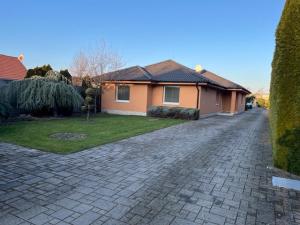 a house with a brick driveway in front of a house at MAX Apartmán in Trstice