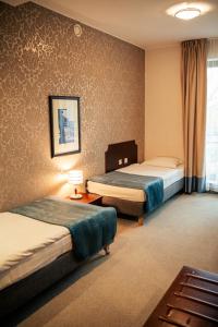 Posteľ alebo postele v izbe v ubytovaní Hotel Kuracyjny Spa & Wellness