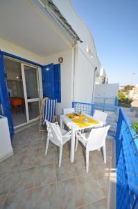 a table and chairs on the balcony of a house at La Casa Dei Marini in Lido Marini +14 photos