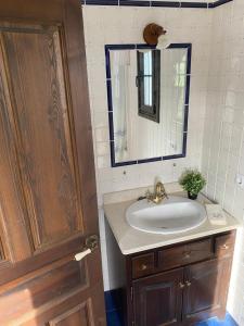 a bathroom with a sink and a mirror at Villa del Mar in Villaviciosa +15 photos