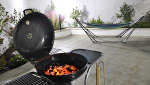 a grill with a hammock in a backyard with a hammock at Casa Dei Marini in Lido Marini