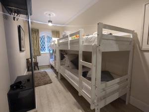 a room with two bunk beds in a room at The Stables Apartment at Cefn Tilla Court, Usk in Usk
