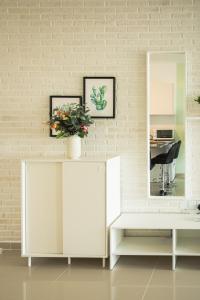 a dressing room with a white cabinet and a mirror at Spacious One Bedroom Apartment in Caesar Resort & SPA, Long Beach in Perivolia tou Trikomou