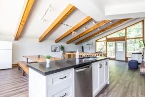 a kitchen with white cabinets and a counter top at Birch View- Balcony-Backyard-Parking-Sauna-Sleeps 20 in Blue Mountains +26 photos