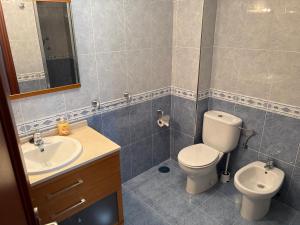 a bathroom with a toilet and a sink at Casa Frijol 20metres from the beach in Los Alcázares