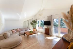 ein Wohnzimmer mit Sofa und Tisch in der Unterkunft Apartmant with Pool 8 in Kaštela