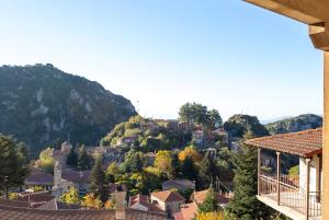 a town on a hill with houses and trees at Miglari in Stemnitsa +57 photos