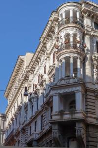 a building with a balcony on the side of it at Donna Margherita Rome Suite & Rooms in Rome