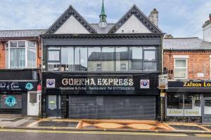 a building with a sign on the side of it at Charming 1-bed Flat in Eastwood in Eastwood