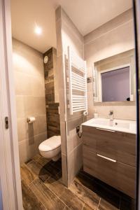 a bathroom with a toilet and a sink at Superbe vue, accès skis aux pieds, très agréable in Courchevel +15 photos