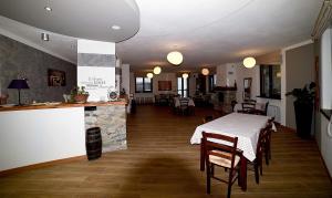 a dining room with a table and a fireplace at Affittacamere La Lea in Roccaforte Mondovì