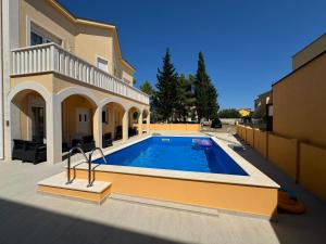 a swimming pool in the backyard of a house at Villa Sunshine in Orebić