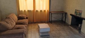 a living room with a couch and a table at Cabaña el diquecito in La Calera +4 photos