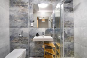 a bathroom with a sink and a mirror at Być Morze in Pobierowo +22 photos