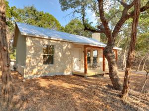 a stone house with a garage at Cabins at Flite Acres - Mountain Laurel in Wimberley