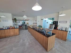 a large room with a counter in a store at Hotel Vivenda dos Corais in Porto De Galinhas