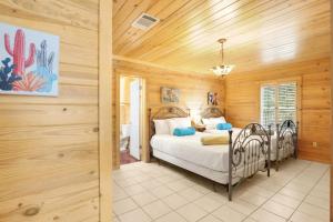 a bedroom with a bed in a room with wooden walls at Wimberley Log Cabins Resort and Suites- The Oak Lodge in Wimberley +32 photos
