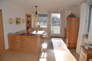 a kitchen with a desk and a table and a window at Appartement Untersberg Blick in Anif